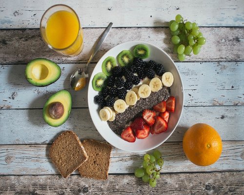 Fresh local Colombian food including avocado and arepas on a wooden table